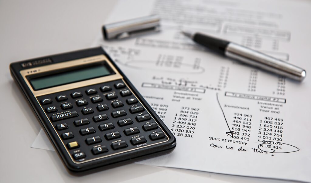 The Woodlands CPA Firm accountant calculating expenses within tax form.